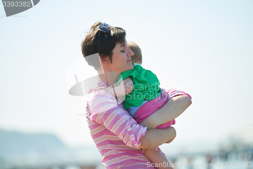 Image of mom and baby on beach  have fun