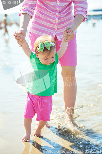 Image of mom and baby on beach  have fun