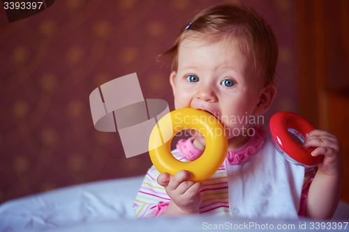 Image of baby playing with toys at home