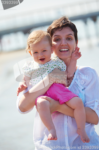 Image of mom and baby on beach  have fun