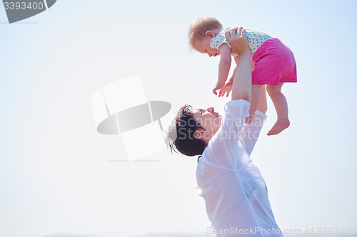 Image of mom and baby on beach  have fun