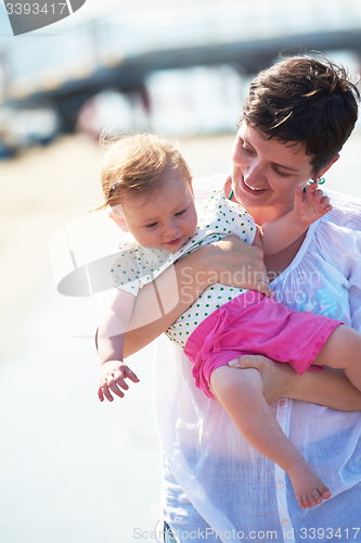 Image of mom and baby on beach  have fun