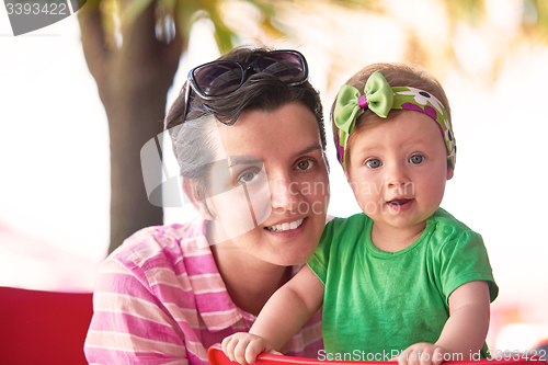 Image of portrait of happy young mother and baby