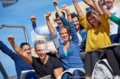 Image of students outside sitting on steps