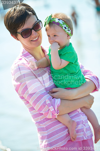 Image of mom and baby on beach  have fun
