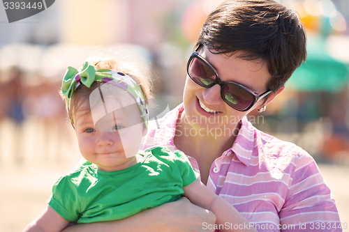 Image of mom and baby on beach  have fun