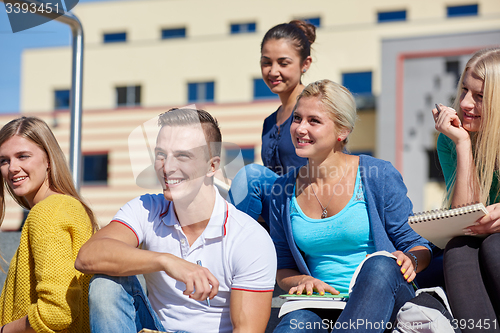 Image of students outside sitting on steps