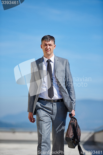 Image of senior  businessman outdoors