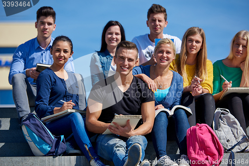 Image of students outside sitting on steps