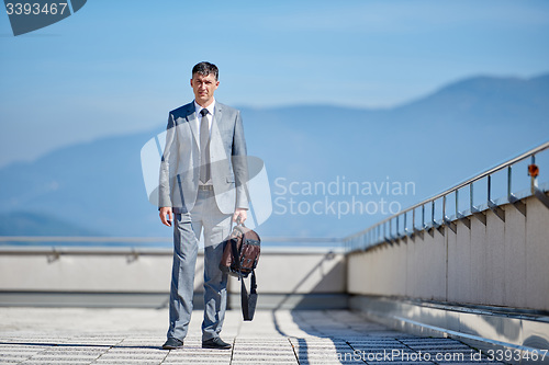 Image of senior  businessman outdoors