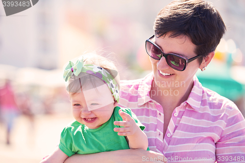 Image of mom and baby on beach  have fun