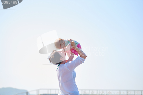 Image of mom and baby on beach  have fun