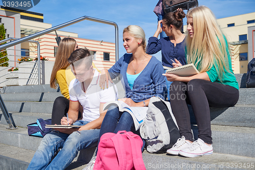 Image of students outside sitting on steps