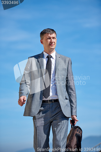 Image of senior  businessman outdoors
