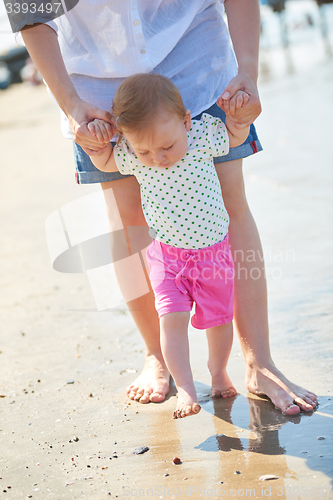 Image of mom and baby on beach  have fun