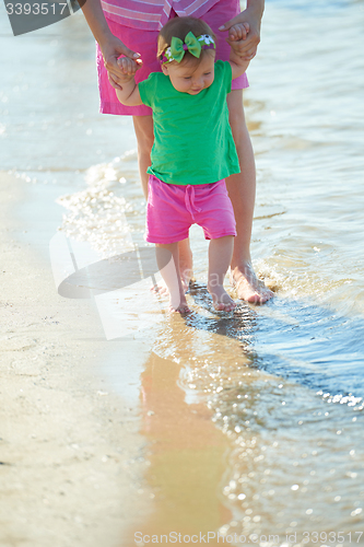 Image of mom and baby on beach  have fun