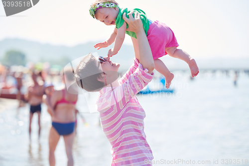 Image of mom and baby on beach  have fun