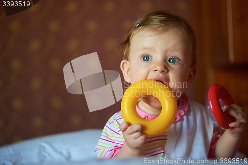 Image of baby playing with toys at home