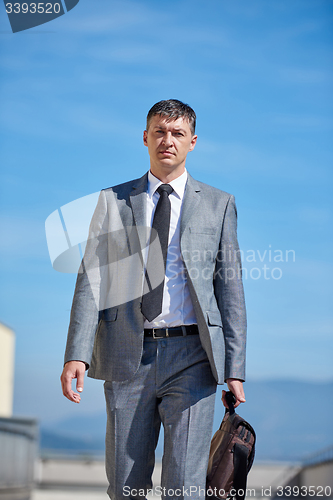 Image of senior  businessman outdoors