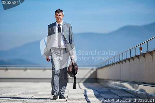 Image of senior  businessman outdoors