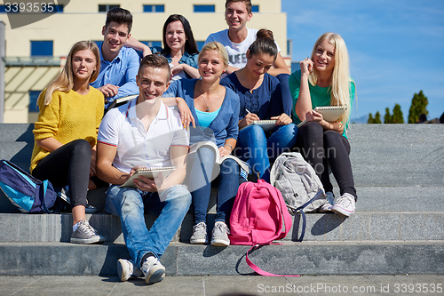 Image of students outside sitting on steps