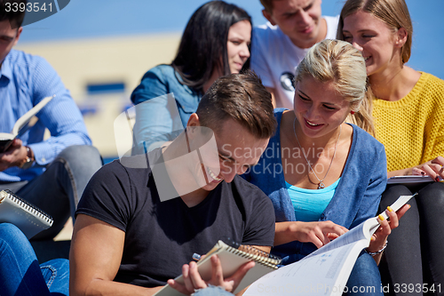 Image of students outside sitting on steps