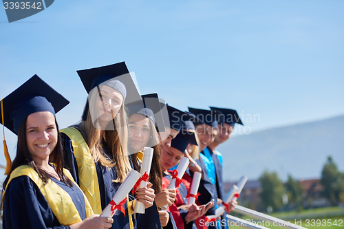 Image of young graduates students group