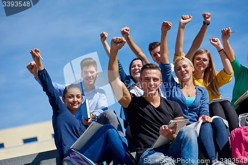 Image of students outside sitting on steps