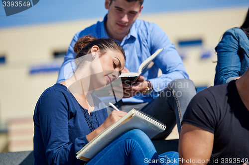 Image of students outside sitting on steps