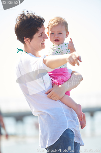 Image of mom and baby on beach  have fun