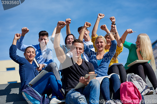 Image of students outside sitting on steps