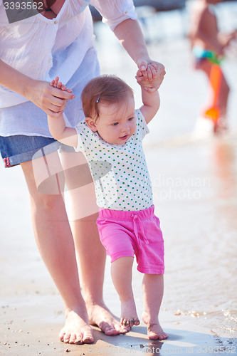 Image of mom and baby on beach  have fun