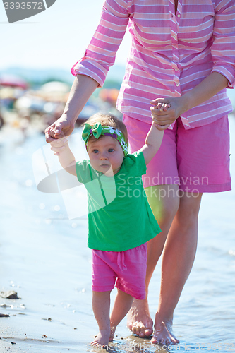 Image of mom and baby on beach  have fun