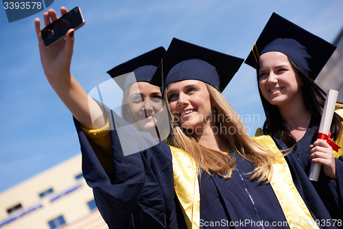 Image of students group in graduates making selfie