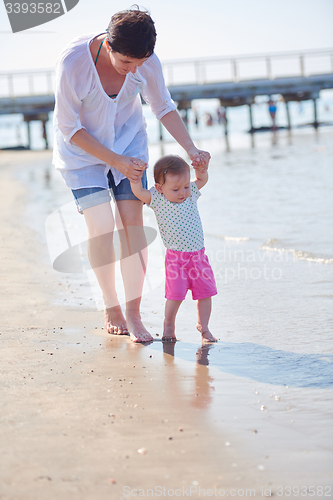 Image of mom and baby on beach  have fun