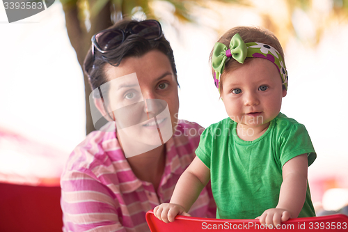 Image of portrait of happy young mother and baby