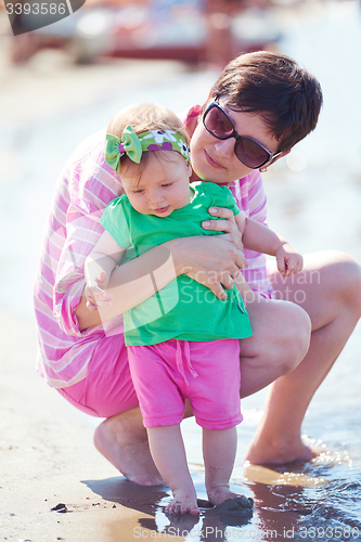 Image of mom and baby on beach  have fun