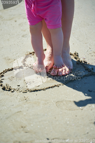 Image of mom and baby on beach  have fun