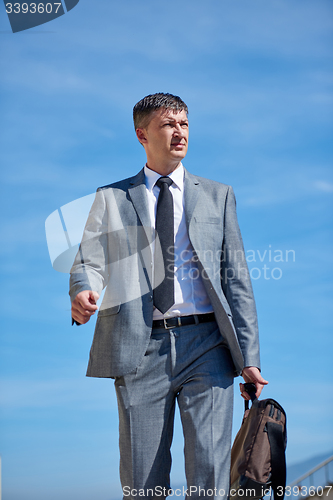 Image of senior  businessman outdoors