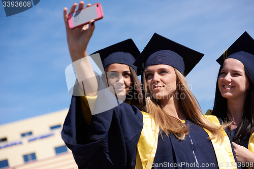 Image of students group in graduates making selfie