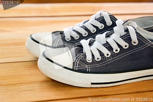 Image of Pair of sneakers on the wooden floor