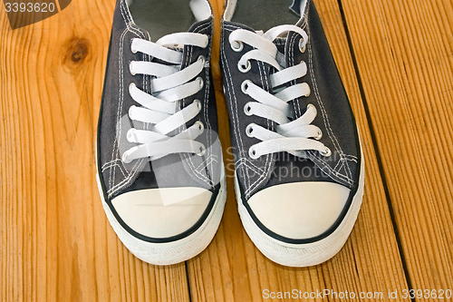 Image of Pair of sneakers on the wooden shield