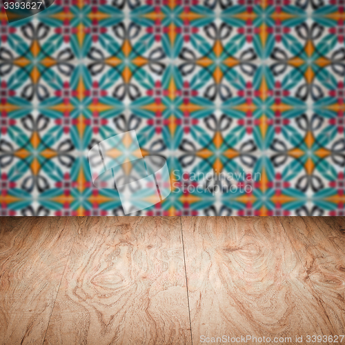 Image of Wood table top and blur vintage ceramic tile pattern wall
