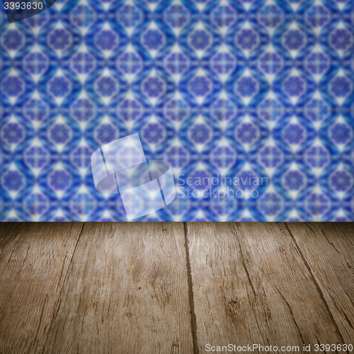 Image of Wood table top and blur vintage ceramic tile pattern wall