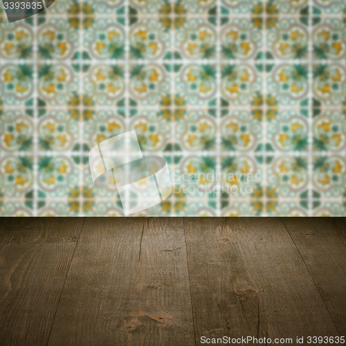 Image of Wood table top and blur vintage ceramic tile pattern wall