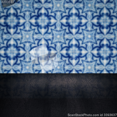 Image of Wood table top and blur vintage ceramic tile pattern wall