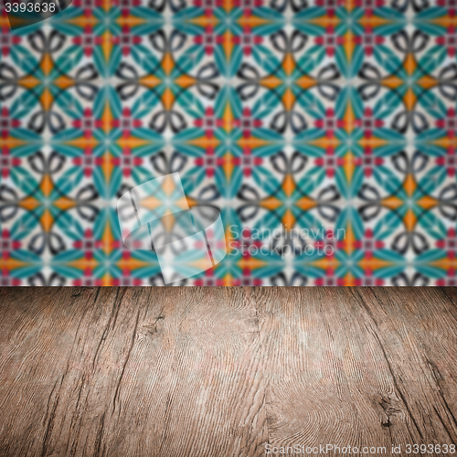 Image of Wood table top and blur vintage ceramic tile pattern wall