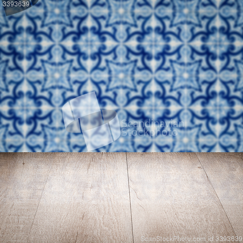Image of Wood table top and blur vintage ceramic tile pattern wall