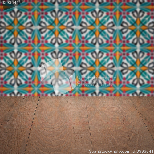 Image of Wood table top and blur vintage ceramic tile pattern wall