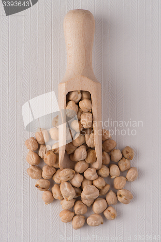 Image of Wooden scoop with chickpeas